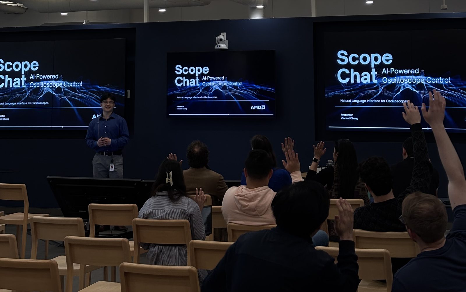 Vincent presenting ScopeChat on stage in front of three screens